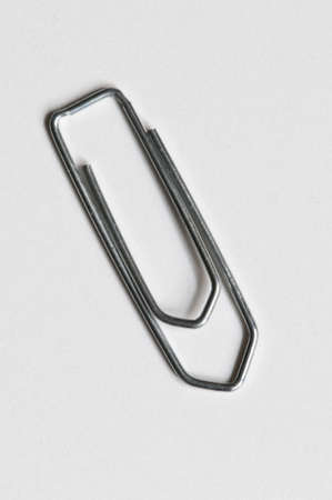 Closeup of a silver paperclip on white backgroundの写真素材