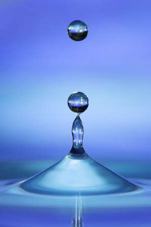 Bouncing drops of water on water surfaceの写真素材