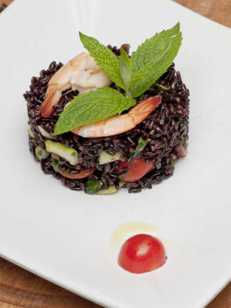 A dish of black rice, shirmos and vegetablesの写真素材