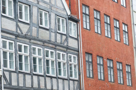 Colorful facade of buildings with white window framesの写真素材