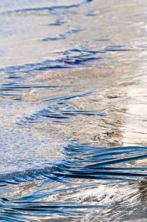 Ice formations on a pond surface in winterの写真素材