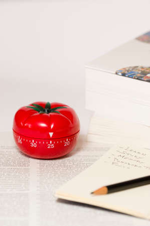 Pomodoro (tomato) technique is a study method that helps avoiding procrastination using a kitchen timerの写真素材