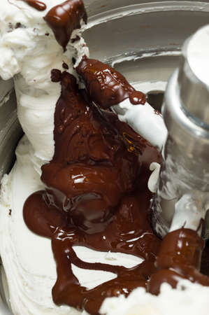 Ice cream preparation with different tools, ingredients, and machinesの写真素材