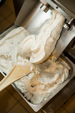 Ice cream preparation with different tools, ingredients, and machinesの写真素材