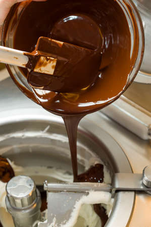 Ice cream preparation with different tools, ingredients, and machinesの写真素材