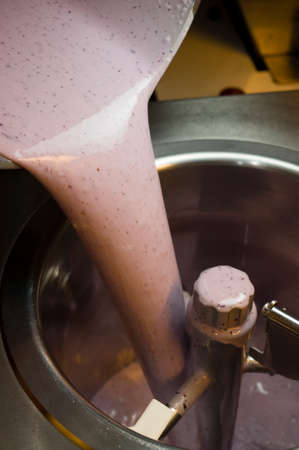 Ice cream preparation with different tools, ingredients, and machinesの写真素材