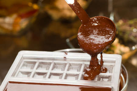 Mixed chocolate poured on bar moldの写真素材