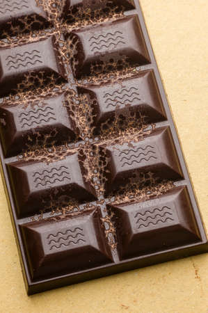 Artisanal chocolate bar with dried fruits and emerging geometric shapes of cocoa butterの写真素材