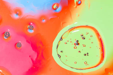 Oil drops on water surface lit from beneath.の写真素材