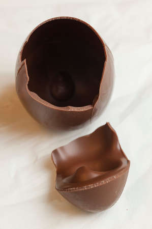 Ingredients and preparation of italian Easter milk and dark choccolate eggs and sweetsの写真素材