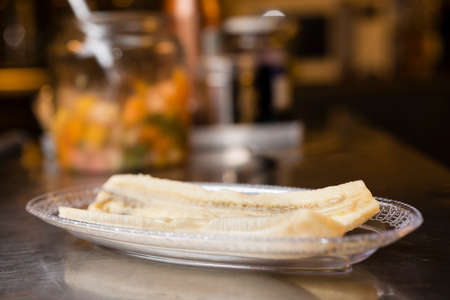 Preparation of artisanal Italian Banana split with ice cream, whipped cream, cherries and cat's tongue coockies.の写真素材