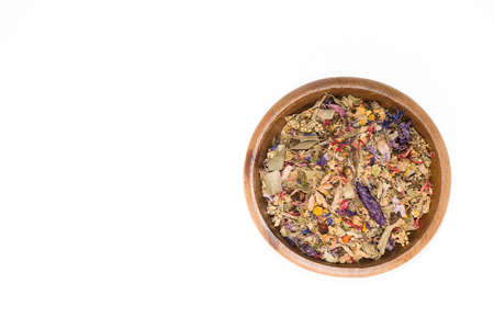 Wooden bowl with potpourri of dried flowers and leaves.の写真素材