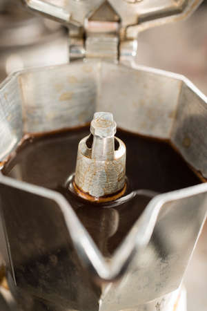 Traditional italian moka machine with fresh hot coffee coming up.の写真素材