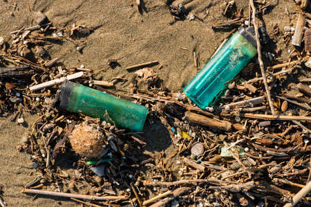 Pollution of Plastic and litter material on sand beach