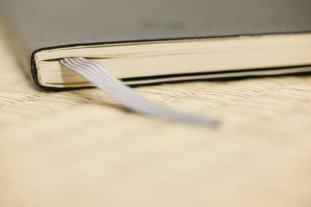 Black cover note book with fabric bookmark.の写真素材