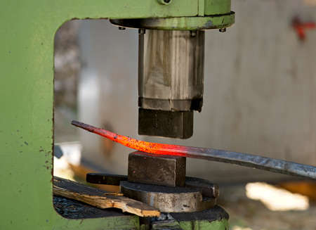 Blacksmith tools and actions forging iron objects.の写真素材