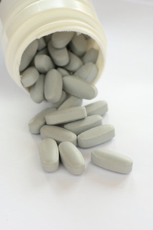 Detail of blue pills in packaging and isolated for healthcare