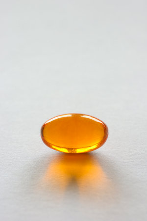 Detail of orange pills in packaging and isolated for healthcareの写真素材