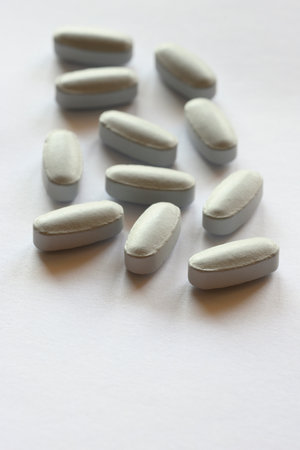 Detail of blue pills in packaging and isolated for healthcareの写真素材