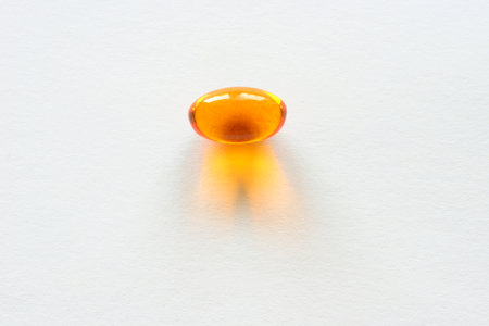 Detail of orange pills in packaging and isolated for healthcareの写真素材
