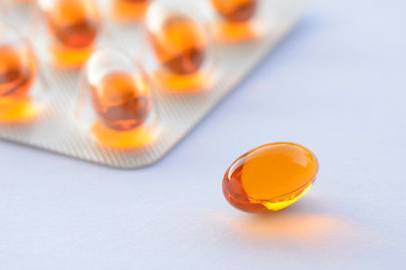 Detail of orange pills in packaging and isolated for healthcareの写真素材