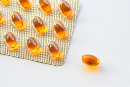 Detail of orange pills in packaging and isolated for healthcareの写真素材