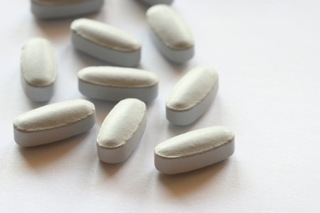 Detail of blue pills in packaging and isolated for healthcareの写真素材