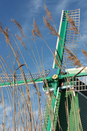Dutch ancient windmill built from wood. typical structure of the Netherlands. old work tools on the river in the village of Zaanse Schansの写真素材