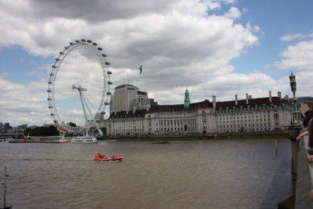 The London Eye on the Thames River on a slightly cloudy spring dayのeditorial素材