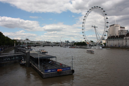The London Eye on the Thames River on a slightly cloudy spring dayのeditorial素材