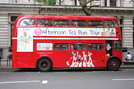 the traditional red double-decker London buses in the traffic on the streets of Sohoのeditorial素材