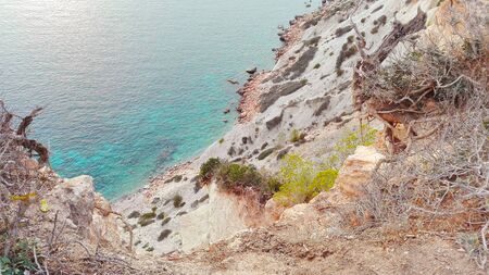 Panorama of the Balearic sea water seen from the high cliff of Cala d'Hort in Ibiza, in front of the magical islet of Es Vedra in Spainの写真素材