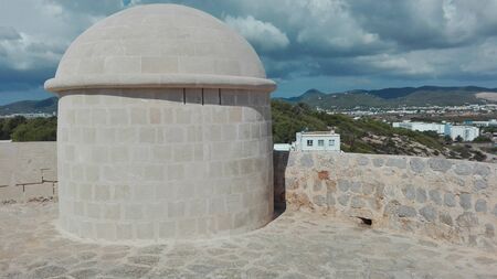 old turrets built on high promontories on the sea to spot pirates and other boats and ships on the coast of ibiza in Spainの写真素材
