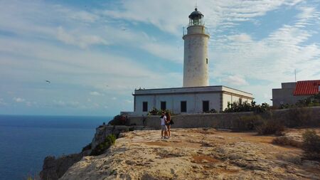 the beautiful lighthouse on the cliff overlooking the island of Formentera in the Balearic Islands in Spainの写真素材