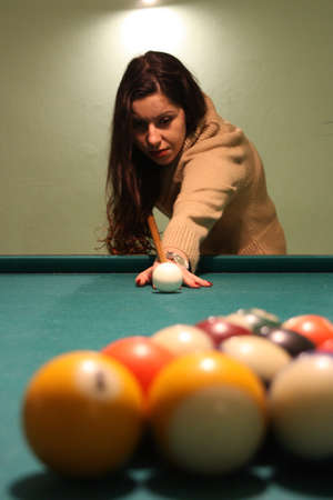 brunette caucasian girl plays billiardsの写真素材