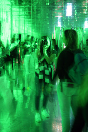 shows abstract psychedelic green color with indistinct figures in the backgroundの写真素材