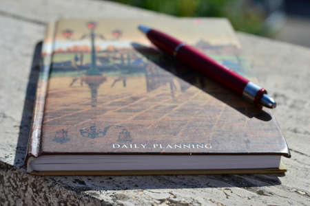 Closed diary with red penの写真素材