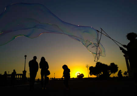 show of soap bubbles at sunset on the terrace Mascagni in Livornoの写真素材