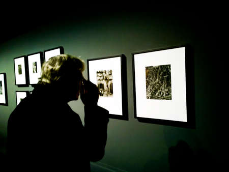 A visitor observes a picture at Cartier Bresson Exibition in MILAN from 11 th November 2015to 7th of February 2016 "CARTIER BESSON e gli altri"のeditorial素材