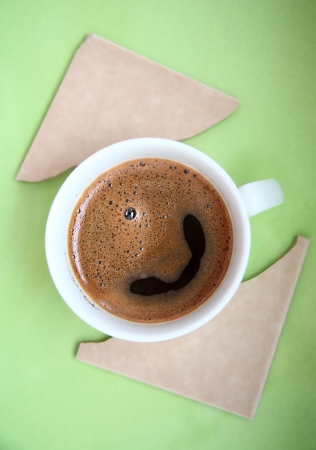 image of cup of coffee against green backgroundの写真素材