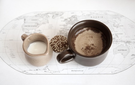artwork  in grunge style,  two cups of coffee, milk jug, cookie,  world political map