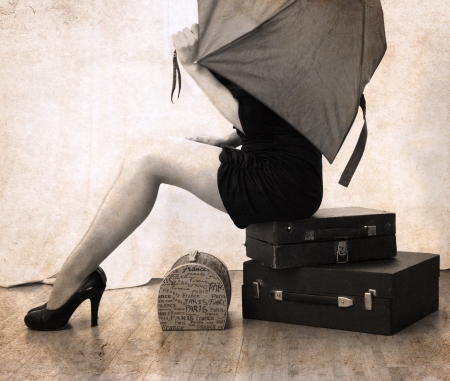 artwork  in vintage style,  beautiful woman waiting with luggageの写真素材