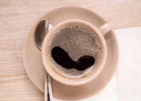 artwork  in painting style, cup of coffee, spoon on wooden tableの写真素材