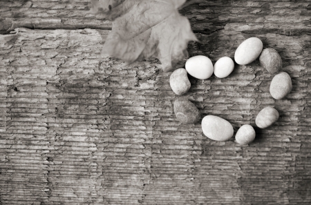 artwork  in retro style,  heart shape of stones, wooden backgroundの写真素材
