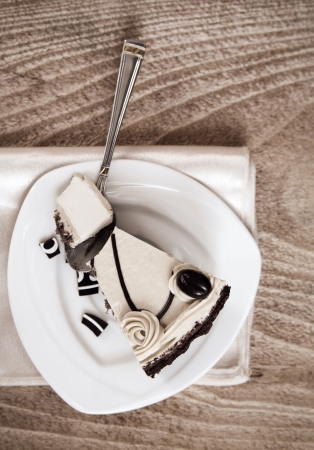 Toned image, Cake, white saucer, spoon, wooden の写真素材