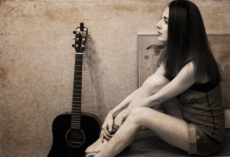 Artwork in vintage style, beautiful young woman, guitarの写真素材