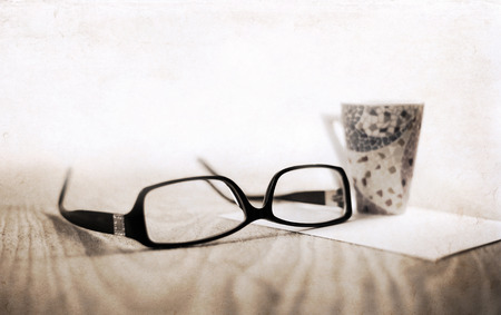 Artwork in retro style, stylish glasses, cup of coffeeの写真素材