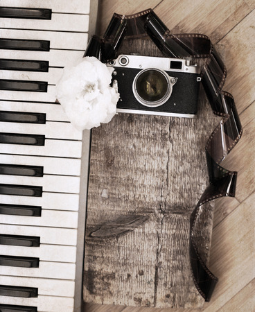 Artwork in retro style, old camera, film, piano, white flowerの写真素材
