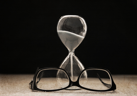 Artwork in retro style,  sandglass, glasses