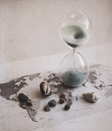 Preparation for the vacation, time is running out, world map, sand glass, sea shellsの写真素材